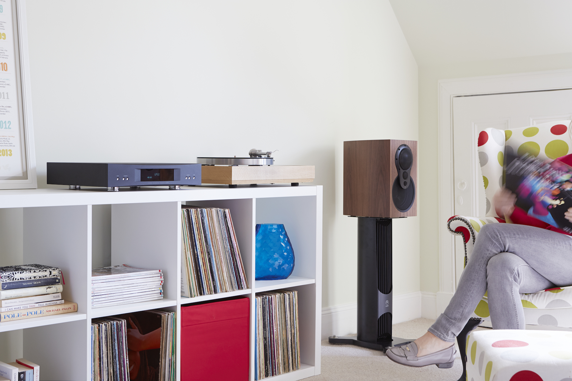 Ett modernt vardagsrum med Hi-Fi-system och högtalare på stativ, idealiskt för musikälskare och vinylsamlingar.